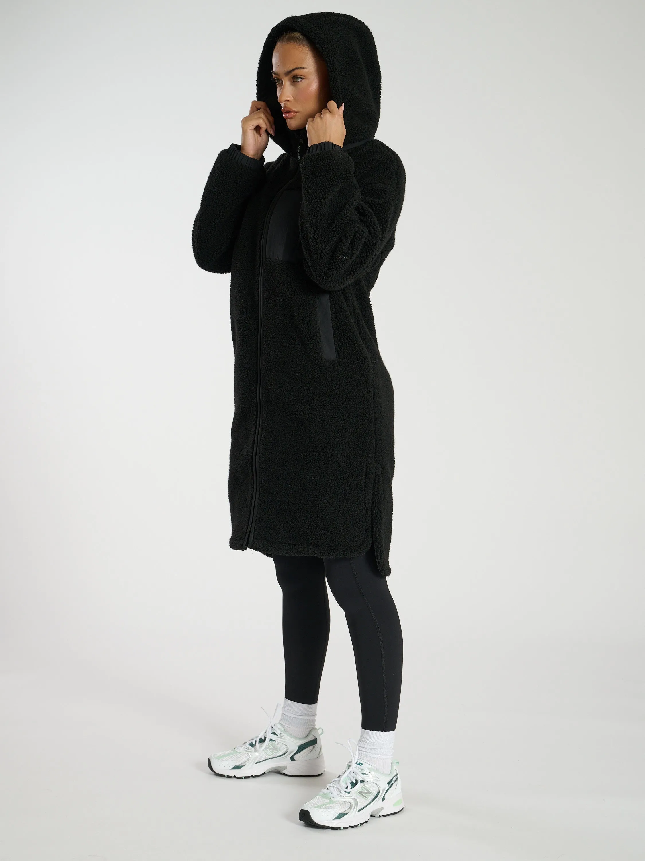 The 'Zip it' hooded midi length teddy fleece coat in black