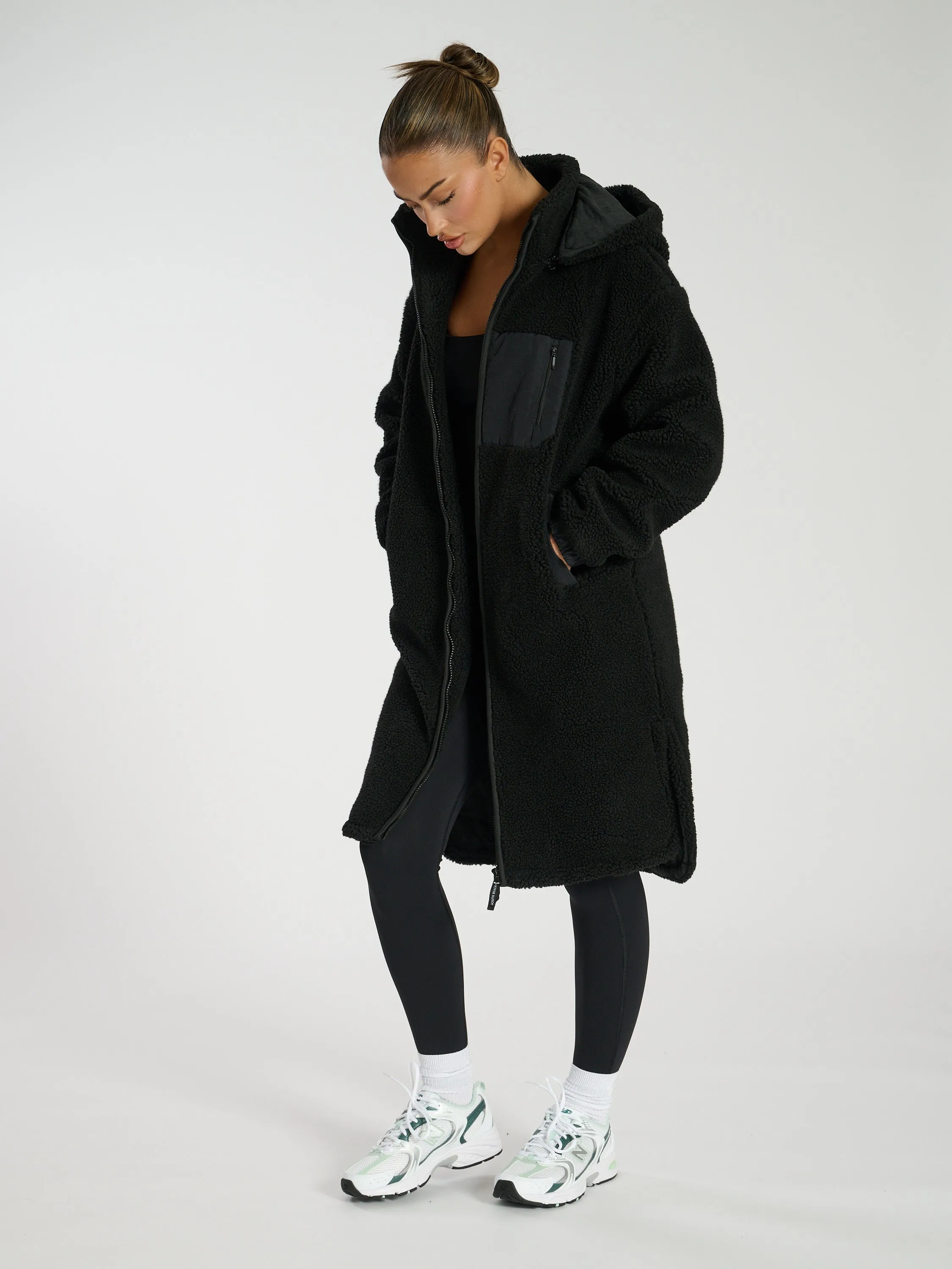 The 'Zip it' hooded midi length teddy fleece coat in black