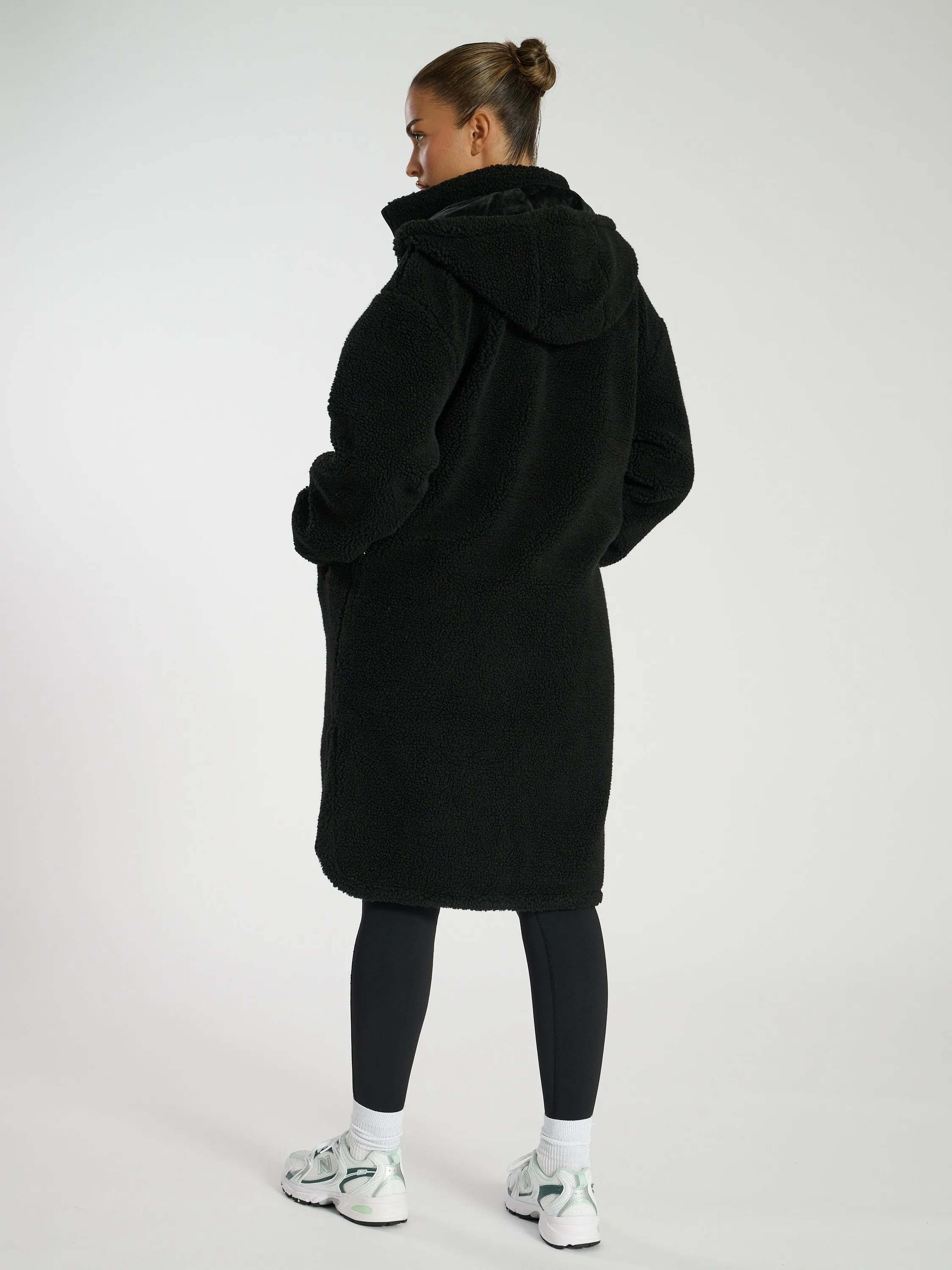 The 'Zip it' hooded midi length teddy fleece coat in black