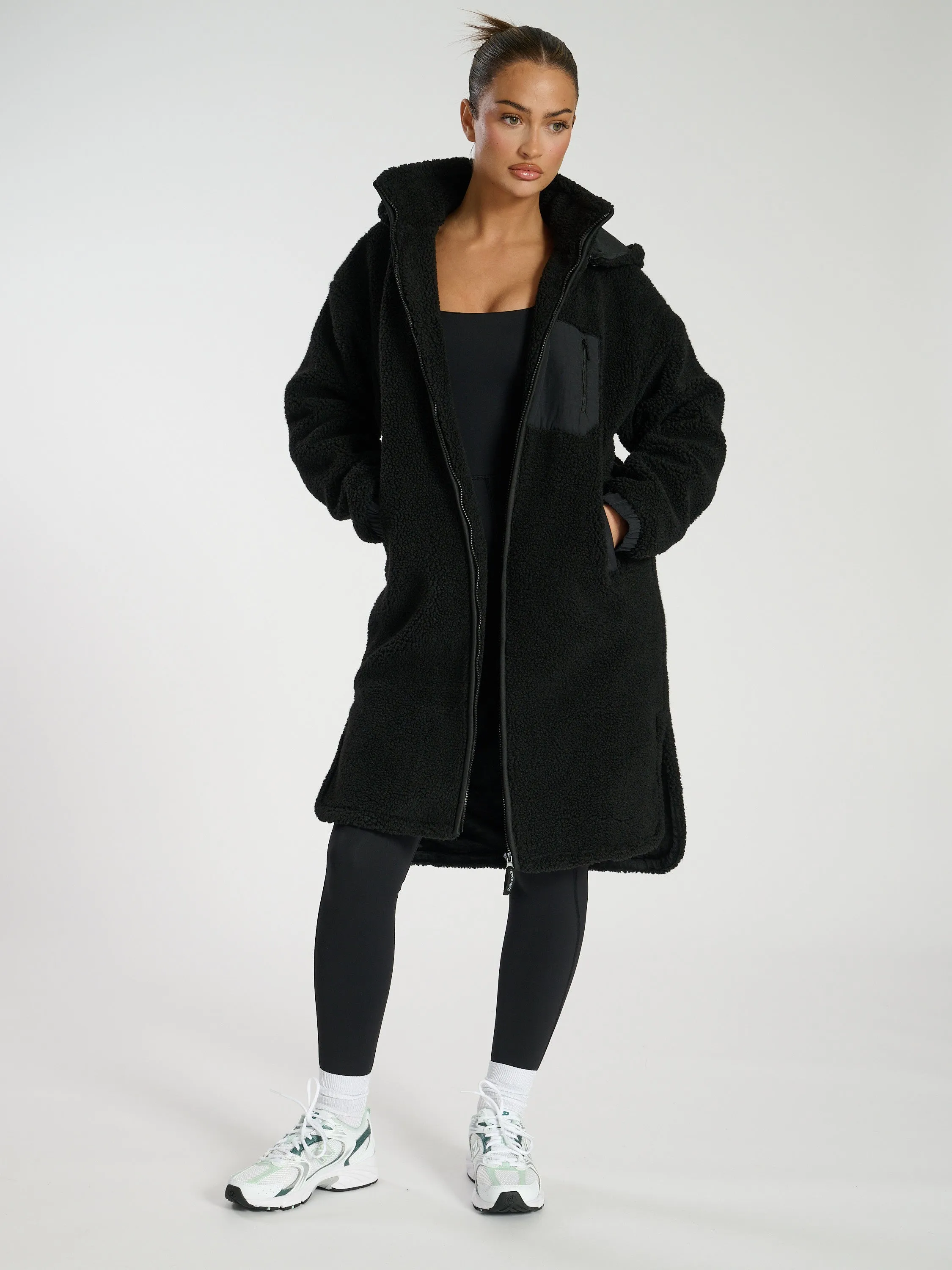 The 'Zip it' hooded midi length teddy fleece coat in black